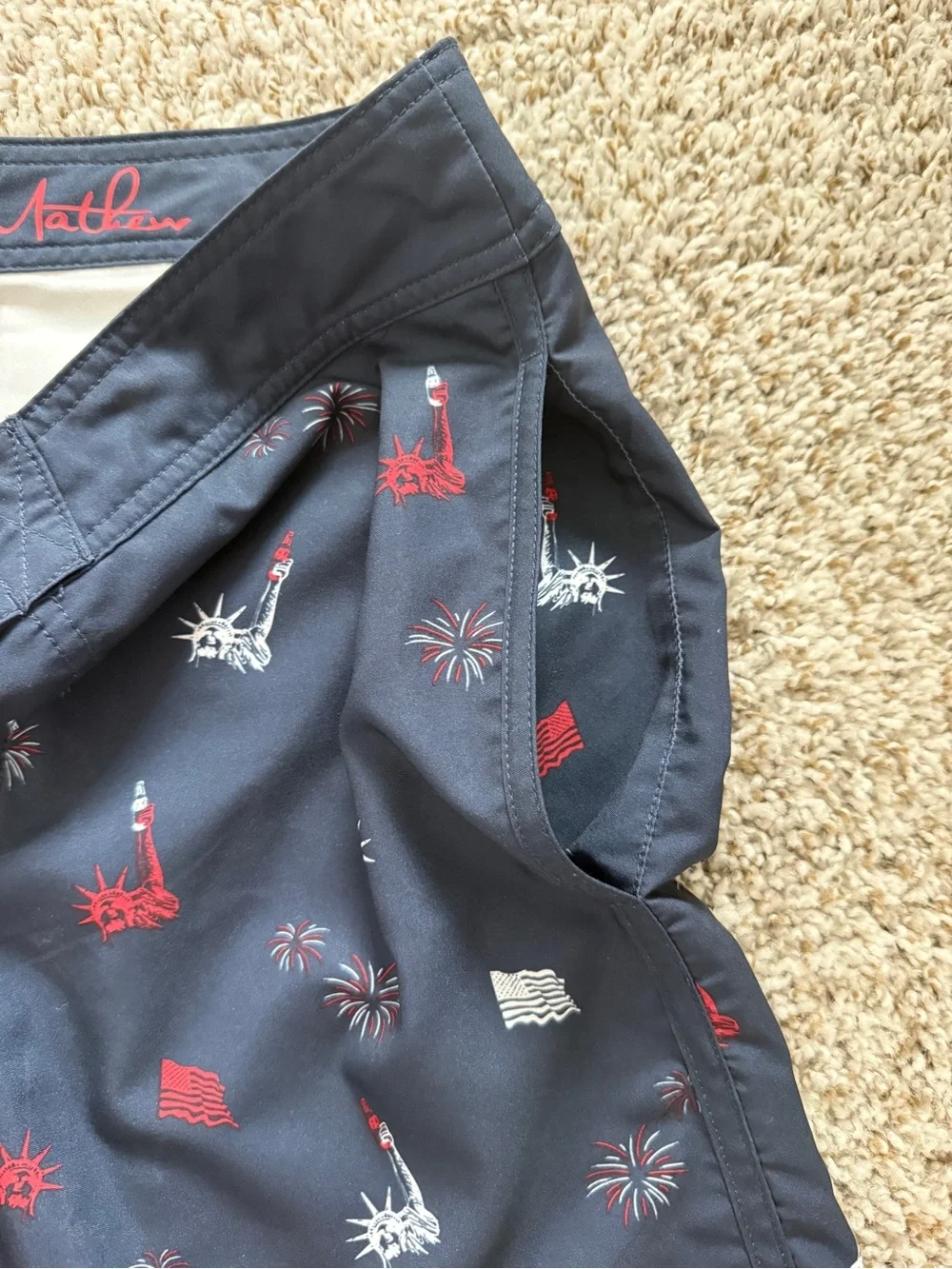 Travis Mathew Navy Swim Shorts with Red & White Liberty Icons